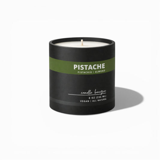 Black candle with a green label on a white background