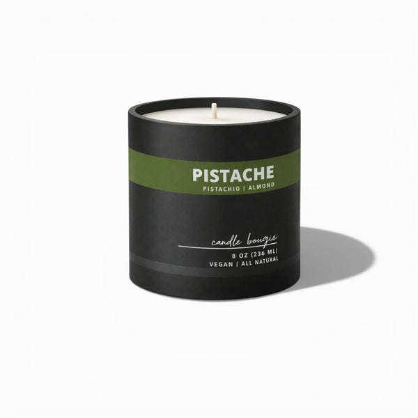 Black candle with a green label on a white background