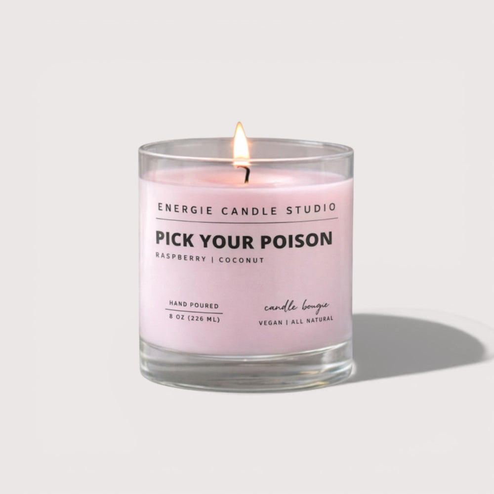 Pink candle with a label from Energie Candle Studio on a white background
