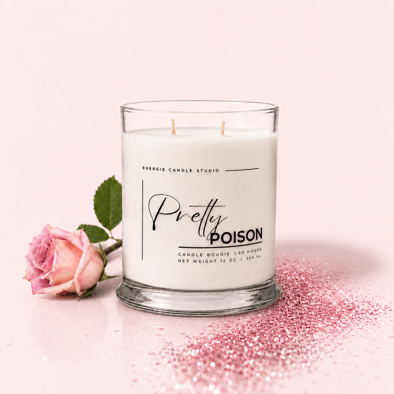 A white two-wick candle in a clear glass jar with a pink rose and pink glitter on a light pink background. The label reads 'Pretty POISON' and 'ENERGIE CANDLE STUDIO'.