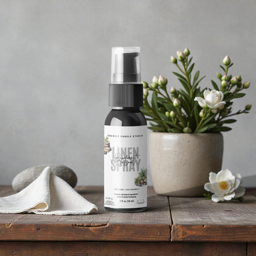 Linen spray bottle on a wooden surface with a plant and towel in the background