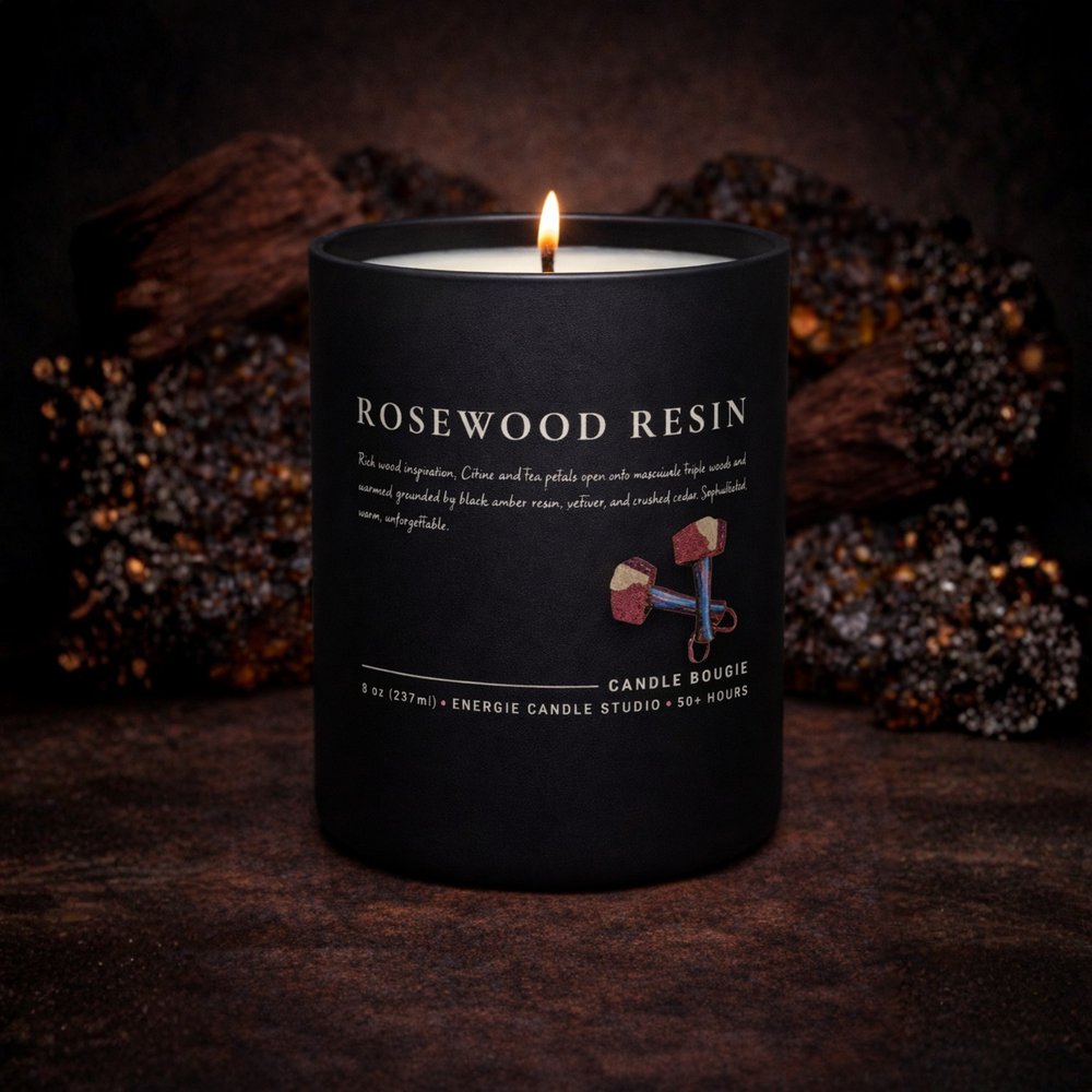 Black candle labeled 'Rosewood Resin' with a dark background