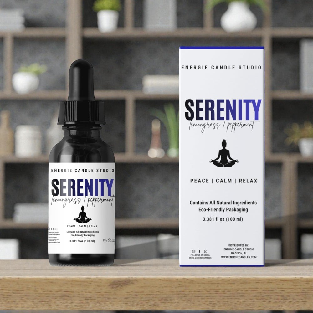 Energie Candle Studio Serenity bottle and packaging on a wooden surface with a blurred indoor background.