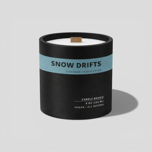 Candle with 'Snow Drifts' label on a light gray background