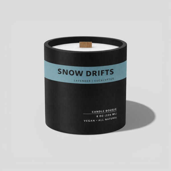 Candle with 'Snow Drifts' label on a light gray background
