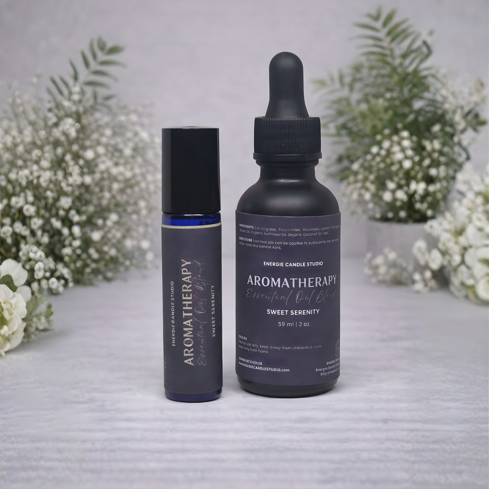 Two aromatherapy bottles on a textured surface with white flowers in the background