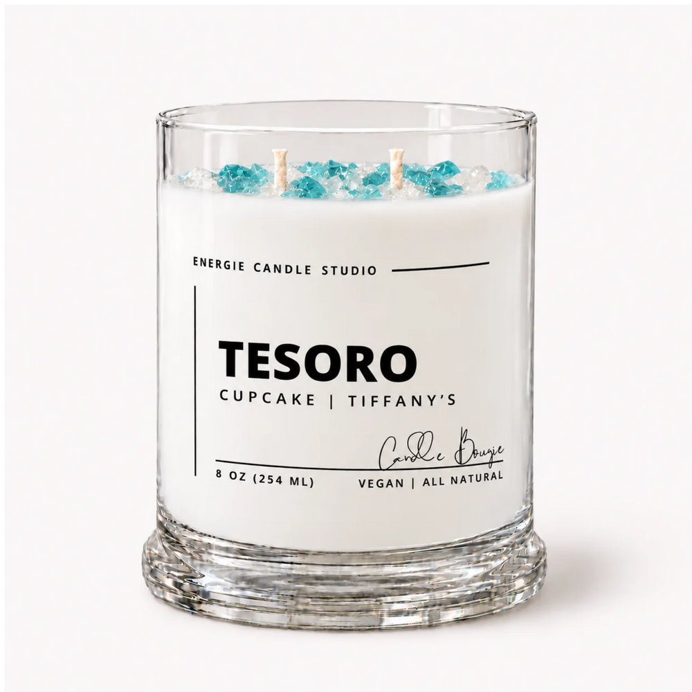 A white scented candle in a clear glass jar with blue decorative beads on top, labeled 'TESORO CUPCAKE | TIFFANY'S' by Energie Candle Studio, on a clean white background.