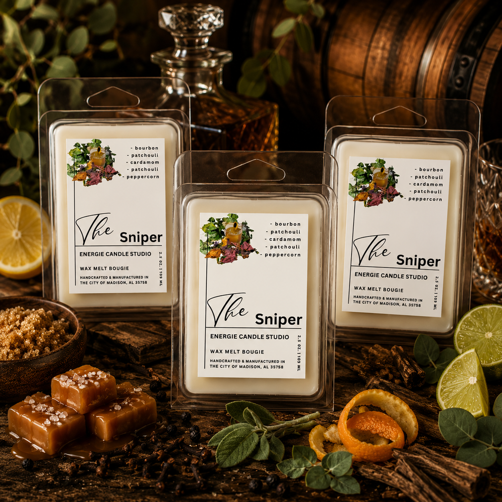Three wax melt packages labeled 'The Sniper' from Energie Candle Studio on a rustic background with spices and fruits.