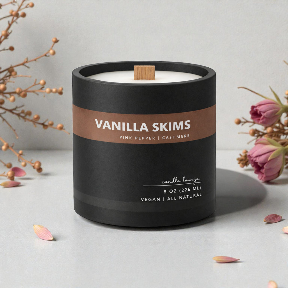 Vanilla Skims candle with decorative flowers on a light surface