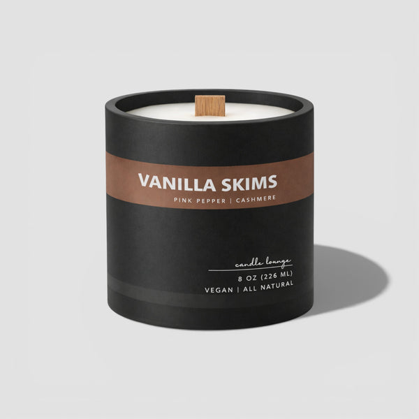 Vanilla Skims candle in a black container on a light gray background