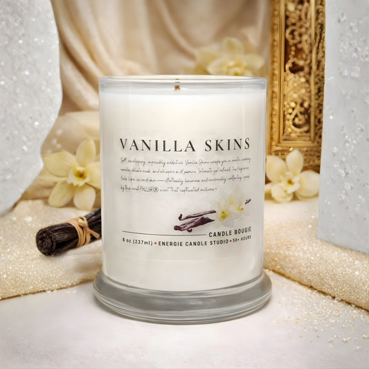 Vanilla Skins candle with vanilla beans and flowers in the background