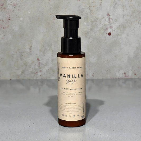 Vanilla Silk lotion bottle on a gray surface with a textured gray background