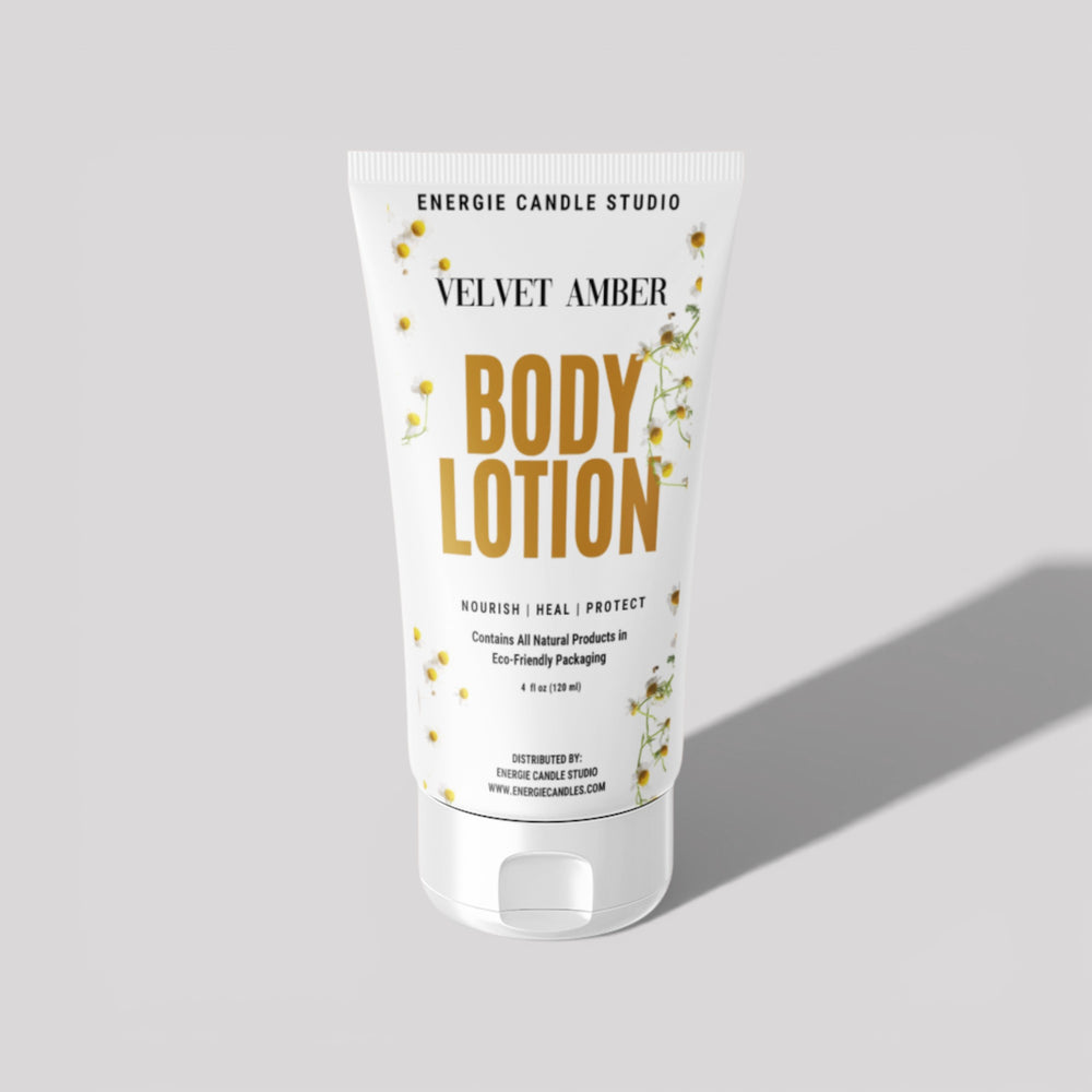 Body lotion tube labeled 'Velvet Amber' by Energie Candle Studio on a light gray background
