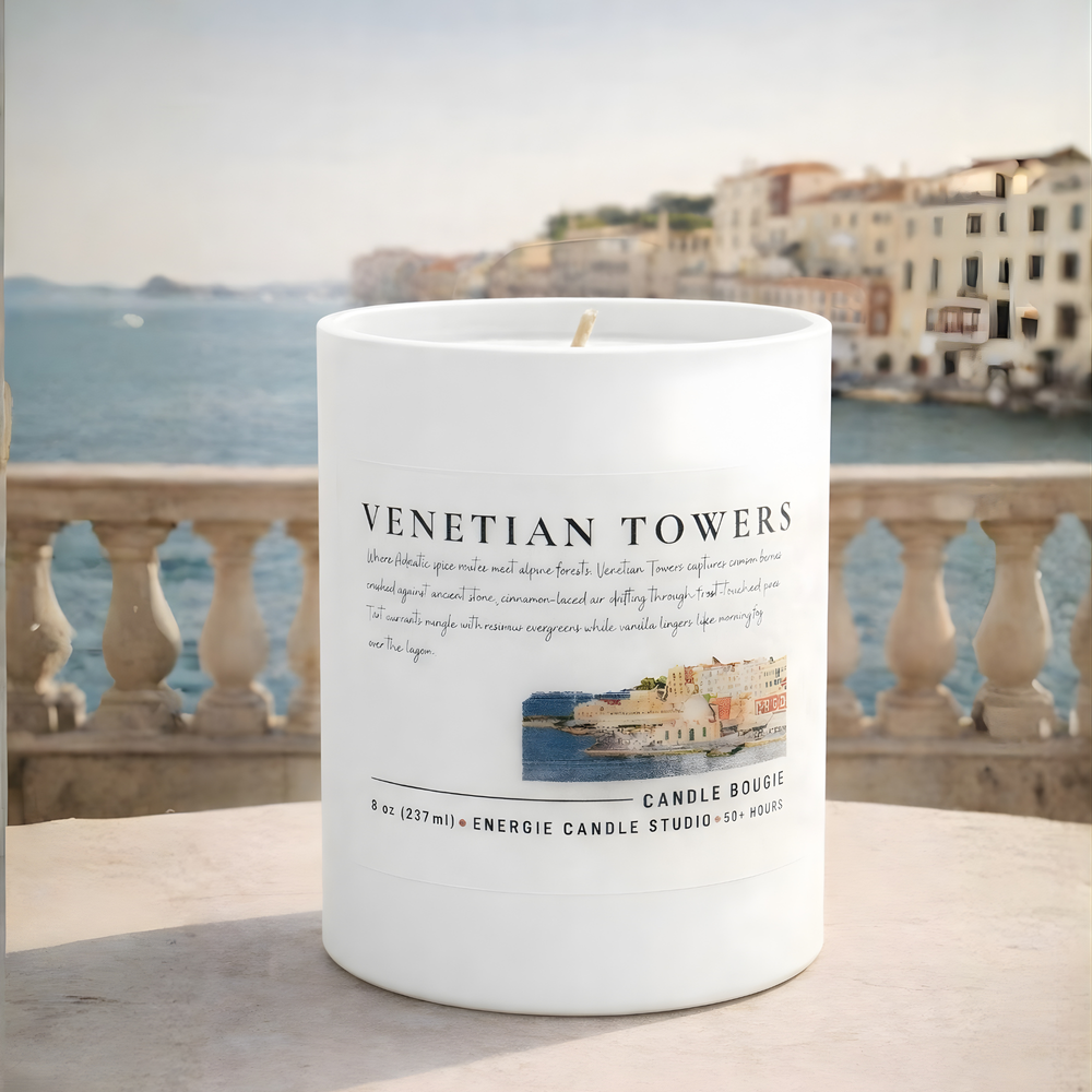 Candle with 'Venetian Towers' label in front of a scenic view