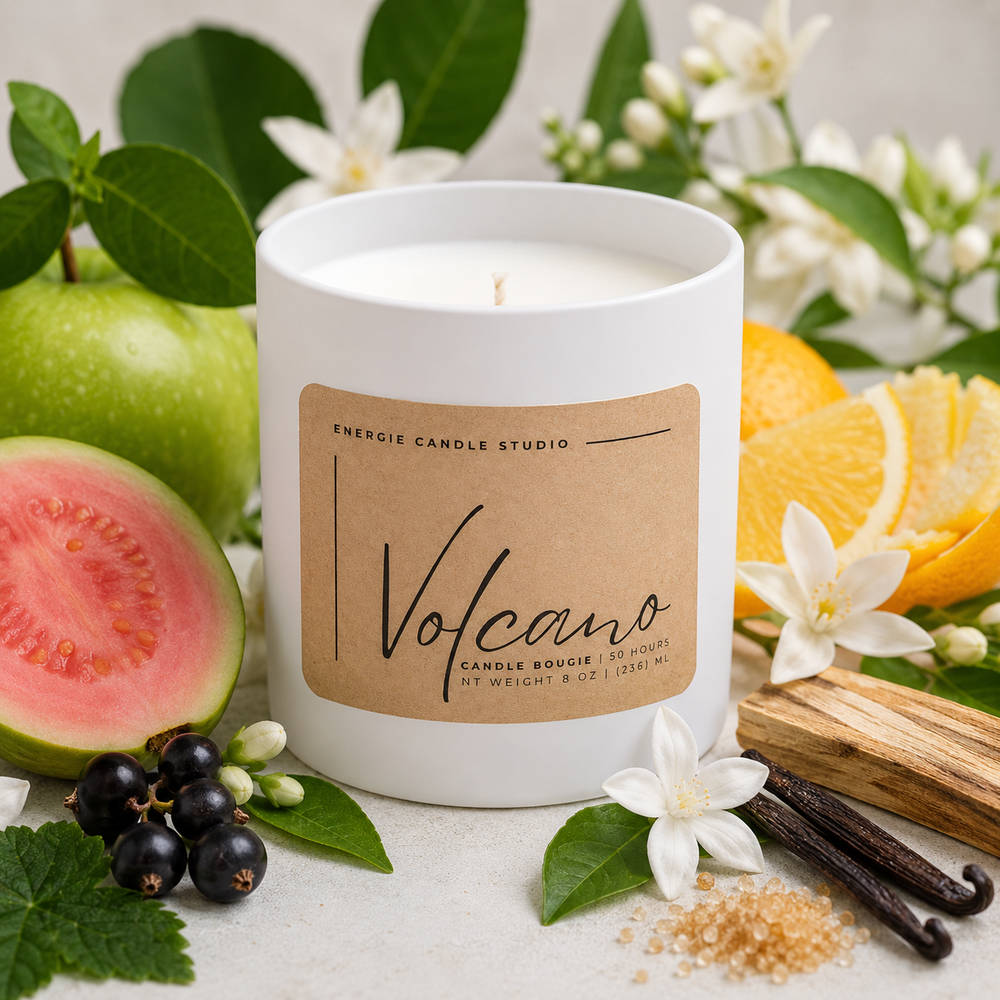 White candle labeled 'Volcano' with fruits, flowers, and leaves on a light background
