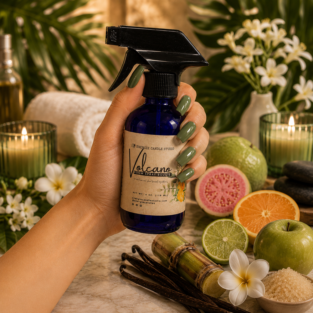 Hand holding a bottle labeled 'Volcano' amidst a spa-like setting with candles, flowers, and fruits.
